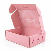 Boîte d'expédition en carton rose poudré pour emballage de produits de beauté, d'ambiance et de parfums, avec logo de marque et inscriptions