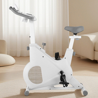 Vélo d'exercice à domicile blanc avec transmission par courroie magnétique, support pour tablette et porte-gobelet pour un entraînement cardio confortable en intérieur