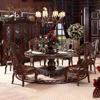 Ensemble de meubles de salle à manger classiques européens de luxe avec table ronde en bois massif, chaises rembourrées et détails sculptés à la main