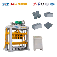 Machine automatique de production de blocs creux en béton QTJ4-40 à commande PLC, pression hydraulique, moteur, petite machine de production de briques en ciment