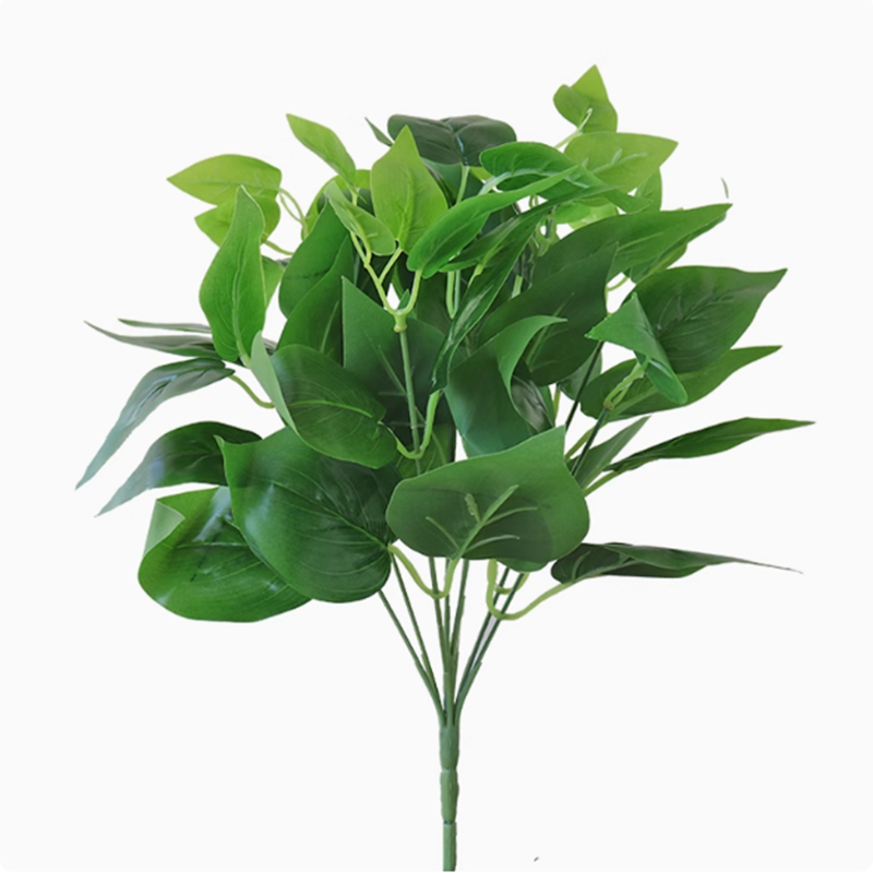 Simulated philodendron and Persian grass floral arrangement for decorating a background wall