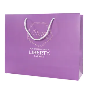 Bolsa de papel de regalo de compras de embalaje de ropa personalizada con asa de lujo púrpura boutique bolsas de papel para joyería de boda cosmética