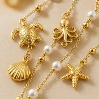 Collier Y en or PVD 18K avec perles et breloques animaux marins (étoile de mer, dauphin, tortue, pieuvre) – Colliers délicats en gros pour OEM