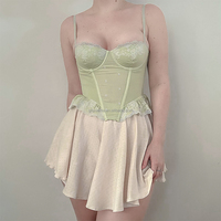 Mini-jupe courte d'été taille haute avec détail nœud personnalisé, en maille transparente à œillets et dentelle, pour soirée, et robe corset sexy pour femme