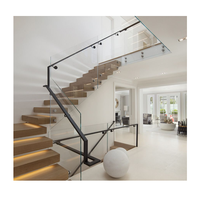Escaliers flottants modernes en forme de L avec garde-corps en verre et main courante latérale