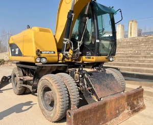 Excavatrice sur pneus CAT M317D2 <span class=keywords><strong>d</strong></span>'occasion à faible nombre <span class=keywords><strong>d</strong></span>'heures de fonctionnement avec dozer frontal, stabilisateurs arrière et ligne de brise-roche préinstallée pour l'asphalte - Product Image 6