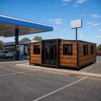 Maison conteneur modulaire extensible en panneaux de bois, à double aile et structure noire, pour station-service et magasin de proximité, vente en gros OEM