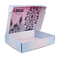 Le fabricant personnalise une boîte d'expédition en carton ondulé mixte bleu clair et rose avec un motif rose et noir