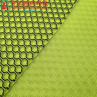 Tissu en maille léger et durable pour femmes, noir et vert, en polyester 100% à mémoire de forme, technique de tricotage sandwich uni teint.