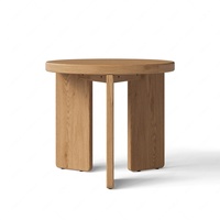 Table basse ronde minimaliste moderne en chêne massif avec trois pieds en bois pour salon