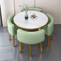 Table à manger ronde de luxe légère avec cadre doré et chaises rembourrées pour salon