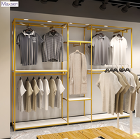 Porte-vêtements sur pied Maxsen en fer doré, taille personnalisée, écologique, avec barres de suspension pour vêtements et étagère de rangement inférieure