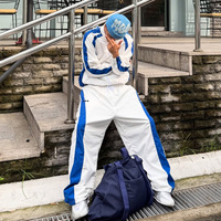 Survêtement personnalisé pour homme en nylon à rayures contrastées, veste zippée coupe-vent à col montant, pantalon large drapé, entraînement avec empiècements latéraux