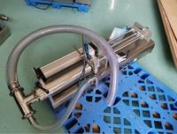 Machine de remplissage semi-automatique à commande au pied pour l'embouteillage d'eau, de jus, d'alcool et de solutions à faible viscosité