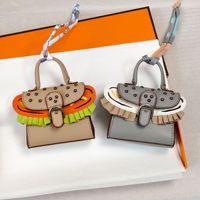 Porte-monnaie miniature de luxe style dessin animé mignon, porte-clés en cuir PU écologique, breloques ovales avec ruban de soie coloré