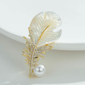 Broche en plumes de haute qualité en gros, plaquée or/argent, avec coquillage naturel et perle blanche, épingle en métal en forme de feuille - Product Image 1