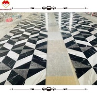 Incrustation de marbre noir et gris assortie blanche pure personnalisée carreaux de marbre jet d'eau modernes motif de sol design