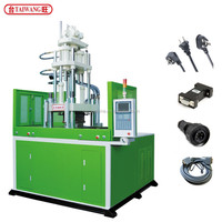 Machine de moulage par injection verticale à double table coulissante pour la fabrication de fiches et l'overmoulage de connecteurs électriques en plastique