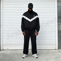 Ensemble de survêtement personnalisé pour homme en nylon, coupe oversize, avec broderie, veste coupe-vent résistante à l'eau à blocs de couleur et pantalon large à jambes larges