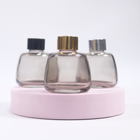 Vente en gros de flacons diffuseurs en verre givré gris mat de 100 ml avec bouchon à vis et impression sérigraphique pour parfum d'intérieur