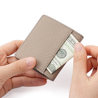 Porte-monnaie mini en cuir véritable ODM OEM, ultra fin, portable, avec bouton-pression, petite pochette de rangement, texture litchi, portefeuille multicolore