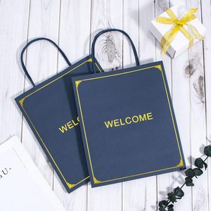 Bolsa de Regalo de Papel Azul Marino de Lujo con Asas Retorcidas con Impresión Dorada de Bienvenida, Papel de Arte Reciclable, Bolsa Plana Estándar - Product Image 1