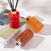 Vente en gros de flacons ronds en verre de 100 ml pour parfum d'ambiance avec bâtonnet en bois et bouchon de couleur rouge-orange