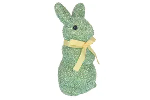 High Quality Blown Decorative Easter Egg Bunny Sits On A Garden Statue Decorated With A Red Pink Green Bow