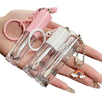 Tube à gloss transparent vide avec un grand pinceau et une chaîne d'accessoires en forme de cœur, contenant à gloss