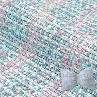 La tela de tweed de moda más vendida es adecuada para la decoración del lugar de alojamiento del programa y se enviará inmediatamente