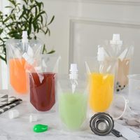 Sacs d'emballage transparents de qualité alimentaire personnalisés boissons debout sacs de buse de liquide de jus alimentaire extrudé pochette de sac de bec de boisson
