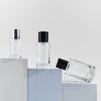 Flacon de parfum en verre rond transparent rechargeable de haute qualité de 25 ml 30 ml 50 ml 100 ml avec couvercle noir/argent disponible