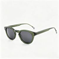 Lunettes de soleil rétro rondes en acétate avec branches à motif à carreaux et verres teintés unis pour usage quotidien en extérieur