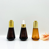 Bouteille d'huile de sérum de sortie d'usine bouteille d'huile essentielle en verre conique avec pompe à bouton-poussoir forme de cylindre emballage Premium