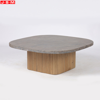 Table basse moderne haut de gamme en pierre naturelle avec base en bois gris clair pour salon