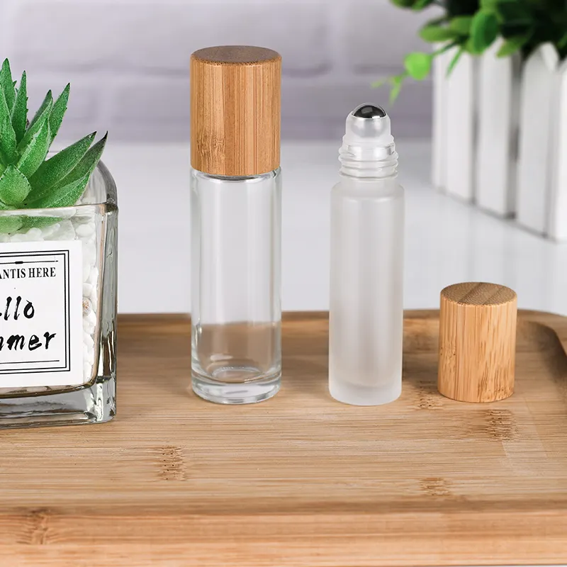 Botella de rodillo transparente de aceite esencial para Perfume, botella de vidrio enrollable con tapa de bambú y rodillos, 10ml