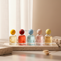 Flacon de parfum rond simple de qualité supérieure, 50 ml, 100 ml, flacon de parfum en verre vide écologique et recyclable avec bouchons à billes colorés