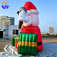 Arche gonflable géante Père Noël rockeur avec guitare, microphone et boîtes cadeaux pour l'entrée de centre commercial, la cour ou les événements de Noël