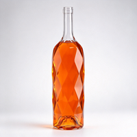 Bouteilles en verre transparent coupées avec liquide orange pour whisky, brandy, vodka, gin et présentation de bar moderne
