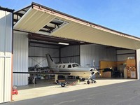 Hangar de acero prefabricado de diseño moderno de gran envergadura, montaje fácil con puerta más grande, edificio de estructura de acero
