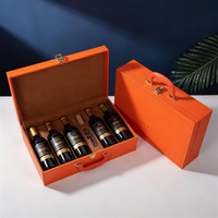Boîte à vin en carton orange avec emblème étoile en relief et vernissage personnalisé pour l'emballage de spiritueux de marque (recyclable et écologique)