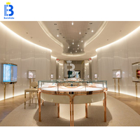 Vitrine de présentation de bijoux circulaire de luxe en or rose sur mesure avec éclairage LED pour boutique de bijoux, kiosque