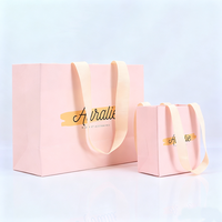Fournisseur de sacs en papier pliables de luxe personnalisés avec poignées en ruban, pour la promotion de la mode, les cadeaux, les cosmétiques et les parfums, couleur rose