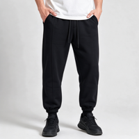 Pantalon de jogging fuselé noir pour homme avec revers, plis sur le devant, couture arrière, empiècement au genou, taille élastique, cordon de serrage et poches obliques, style streetwear