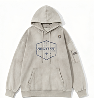 Sweat à capuche oversize avec cordon de serrage, imprimé vintage minimaliste, motif bouclier hexagonal Kornit DTG, poche latérale zippée, effet multi-déchiré, style streetwear