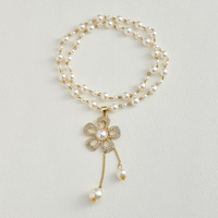 Collier de luxe en perles avec pendentif fleur en strass, élégant pour les soirées, polyvalent pour femme, chaîne de pull, bijoux de luxe
