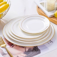 Service d'assiettes modernes en porcelaine fine avec bord doré, écologiques, sans BPA, durables, compatibles micro-ondes, pour mariage