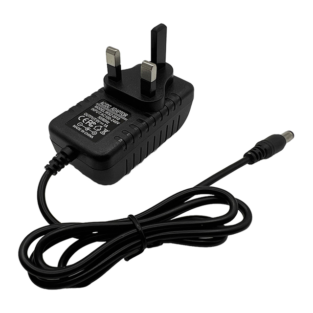 Factory in China 9V 1A 9W UK Plug AC DC Power Adapter with 1 Meter Cable PC Material for LED Lighting and Electronic Devices