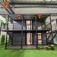 Maison conteneur préfabriquée modulaire extensible à 2 étages, prête à l'emploi, avec salon, cuisine et chambre