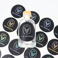 Autocollants personnalisés en papier cuivre avec impression noire et feuille holographique argentée pour bouteilles en verre